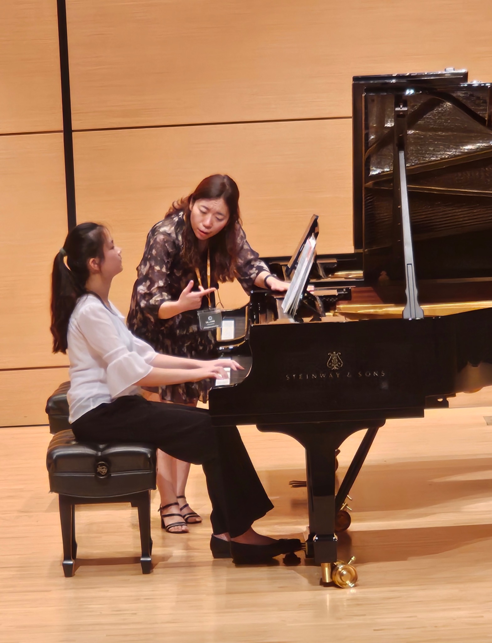Dr. SungEun Park coaching a pianist at the piano
